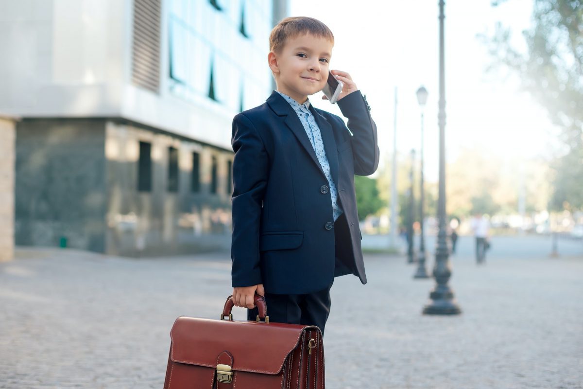 Future businessman with briefcase and phone